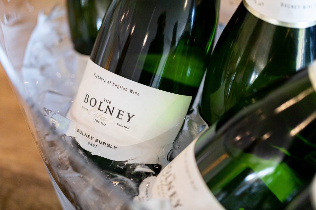Bottles of Bolney Bubbly sparkling wine in an ice bucket to chill