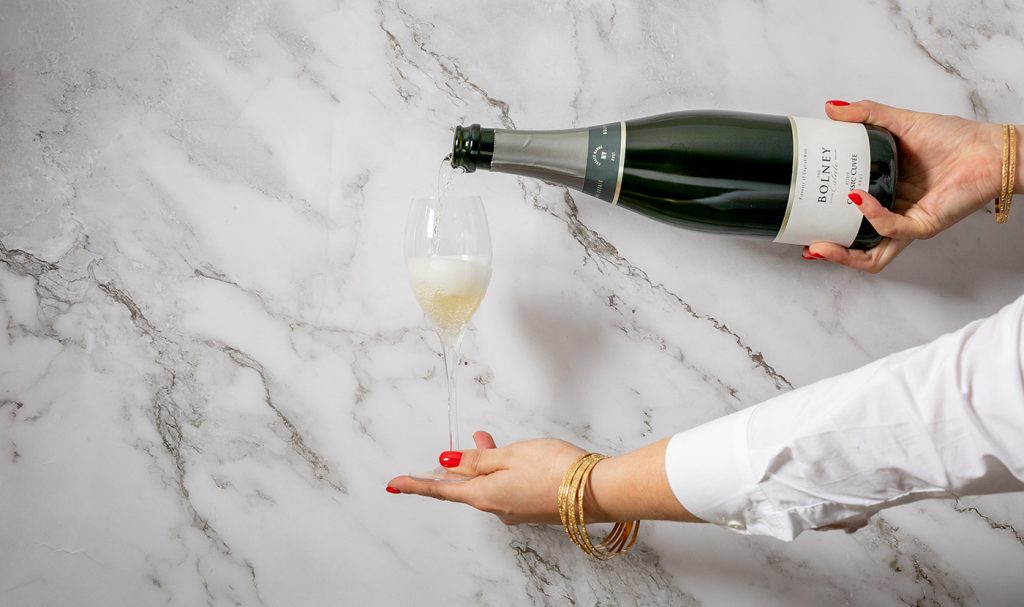 sparkling wine being poured into a glass