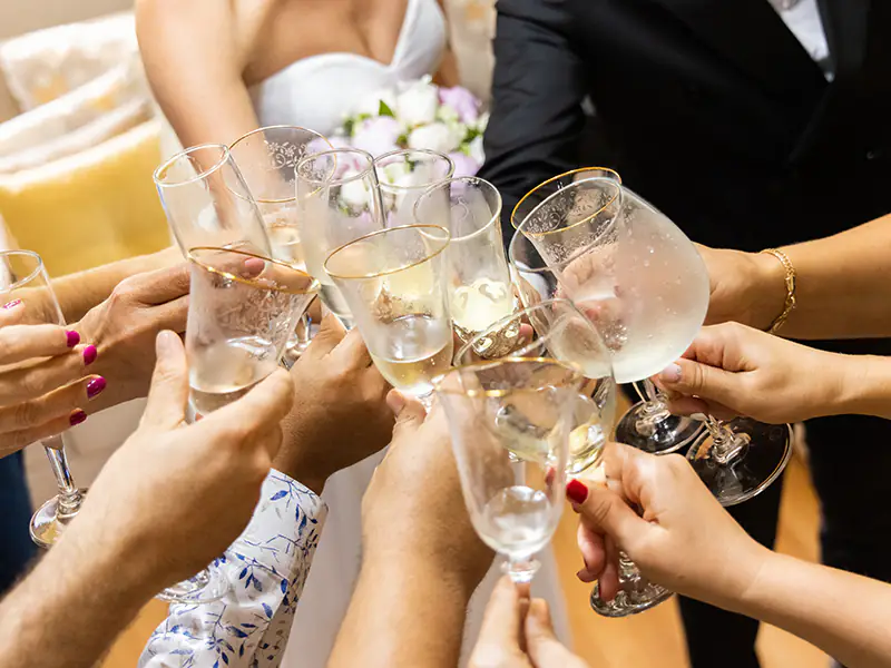 A wedding group toasting with sparkling wine