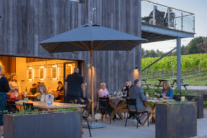 People dining outside at Bolney Estate Cafe in the evening