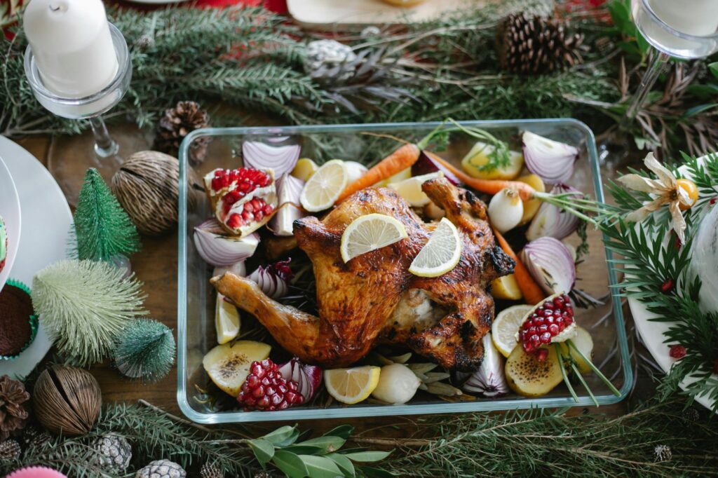 Christmas roast turkey in a tray with garlic and pomegranate