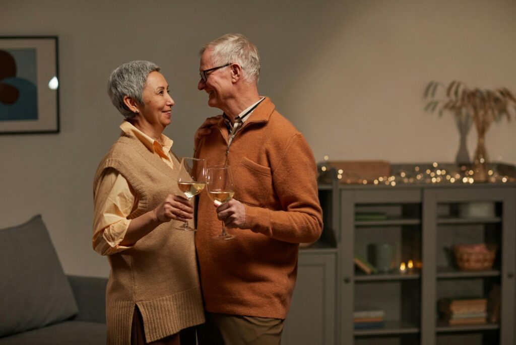 An older couple drinking white wine