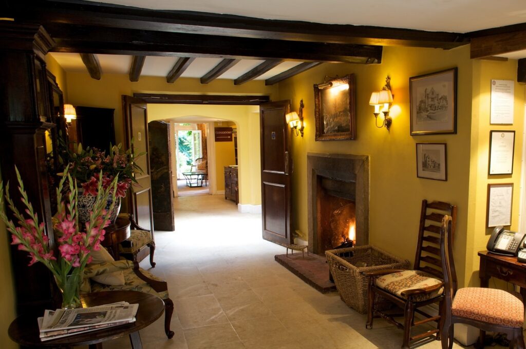 A lobby with timber-beams inside Ockenden Hotel in Susex