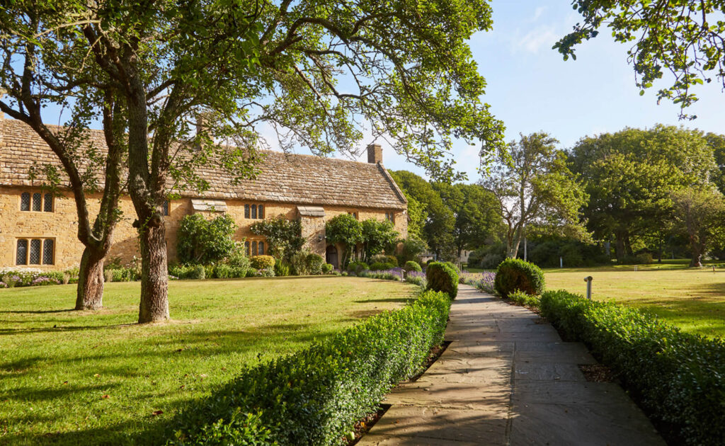 Front view of Bailiffscourt Hotel and lawn