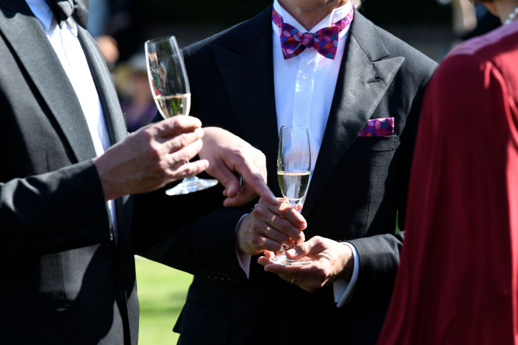 Black tie patrons with English sparkling wine at Glyndebourne Opera House