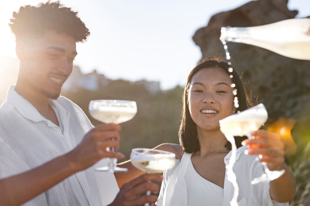 Friends drinking sparkling wine outside in the setting sun