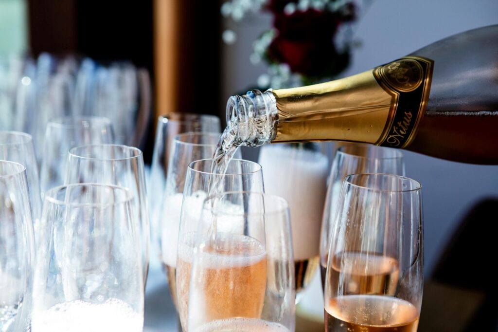 Pouring Champagne into glasses outside