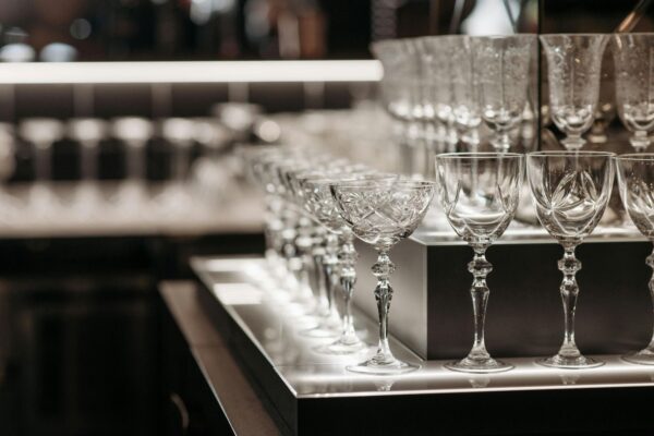 Wine glasses behind a bar