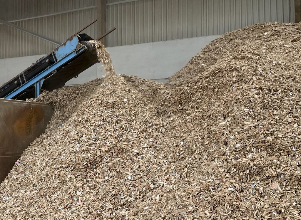 A pile of biomass chips at a waste management facility