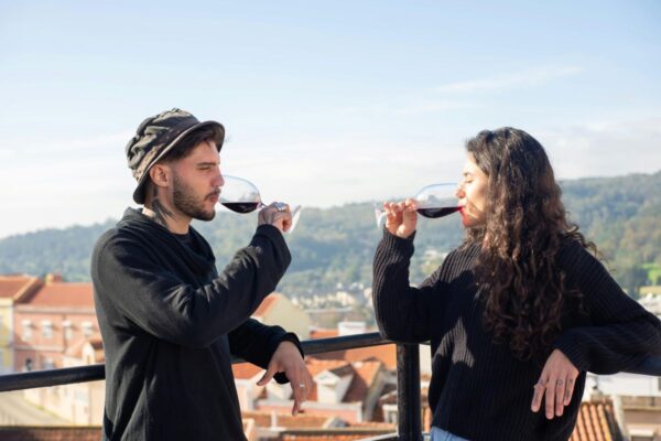 Couple drinking red wine on a rooftop