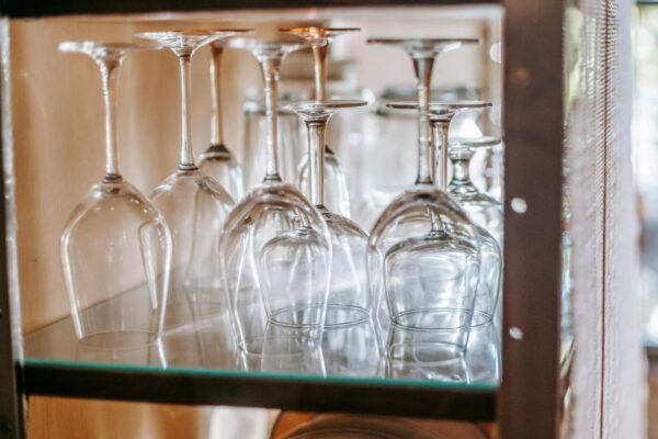 Different types of wine glasses on a shelf