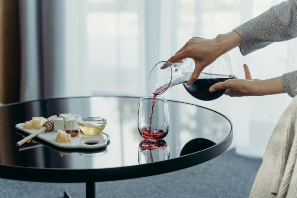 Pouring red wine into a stemless wine glass