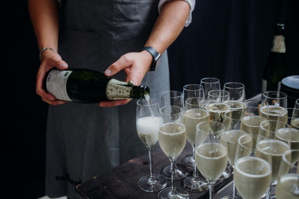 Pouring sparkling wine into tulip wine glasses