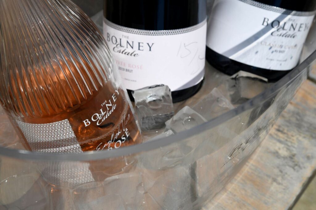Sparkling wine and rose bottles in an ice bucket
