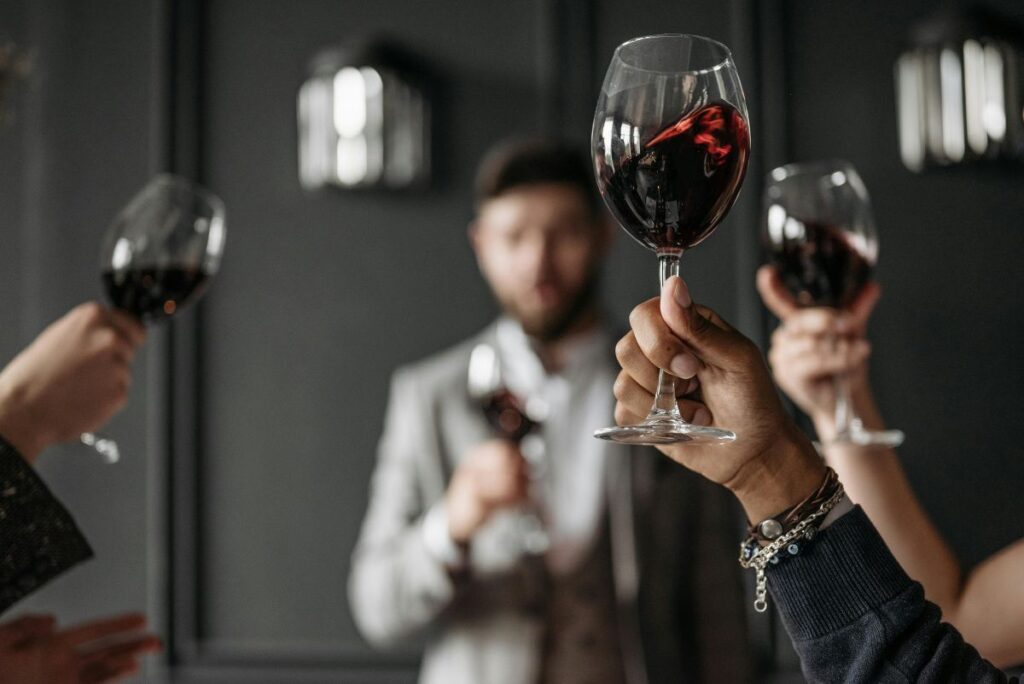 Toasting red wine glasses during a wine tasting session