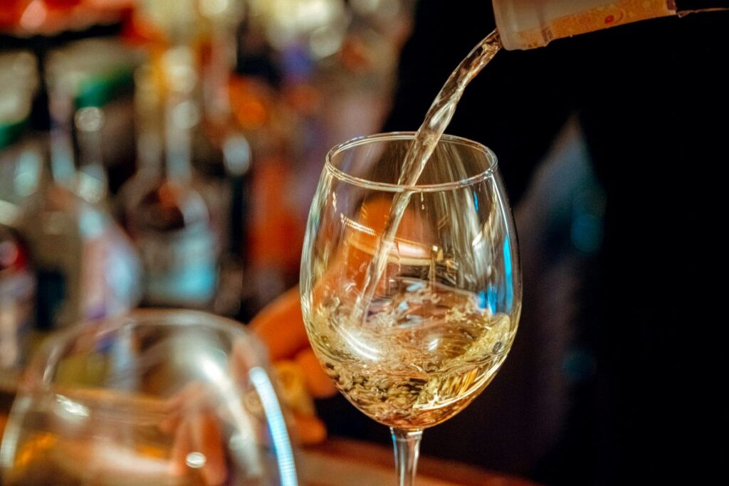White wine poured into a medium-sized wine glass