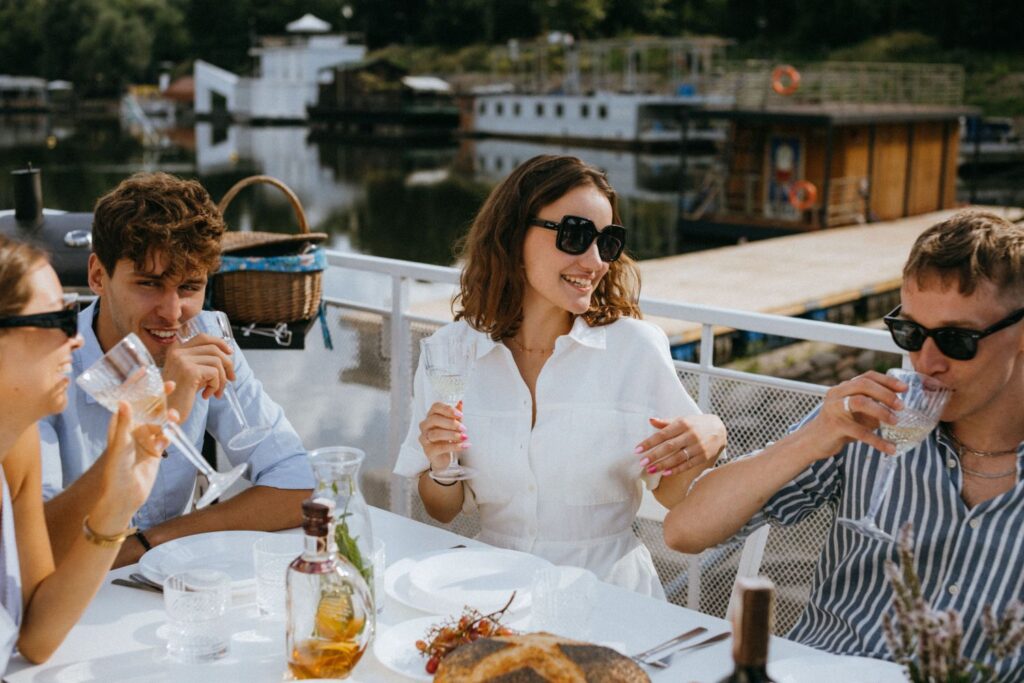 Friends enjoying wine by the waterside
