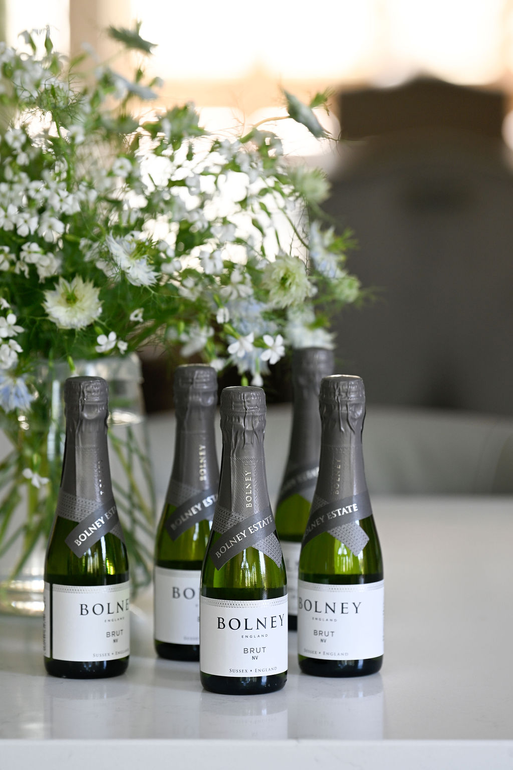 Miniature bottles of Bolney Bubbly next to flowers