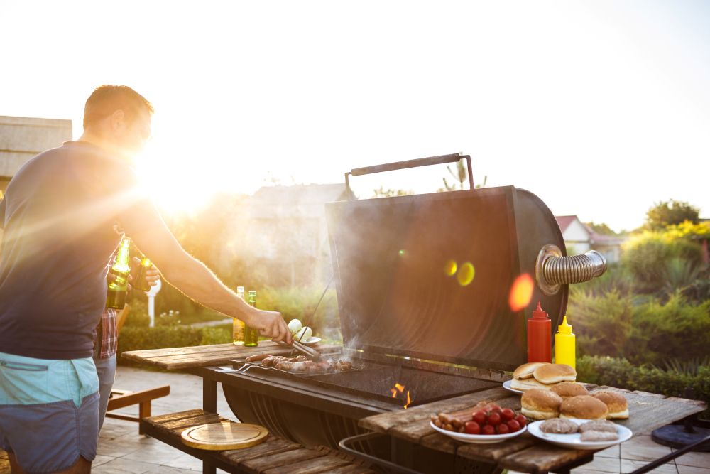 Men cooking on a BBQ in the garden