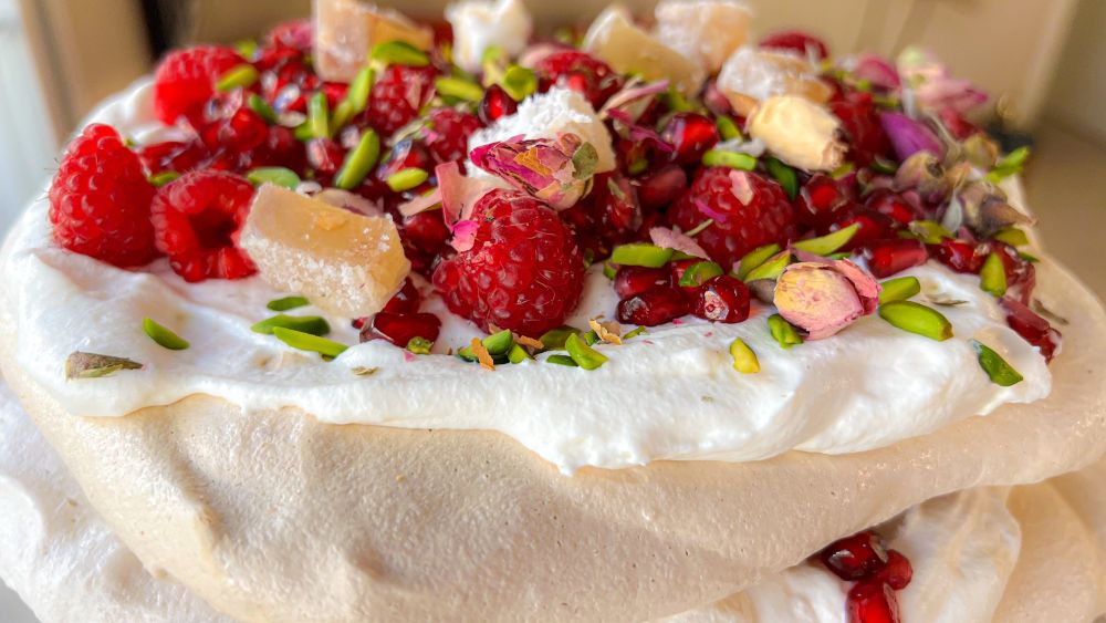 Summer pavlova with red fruit and pistachios
