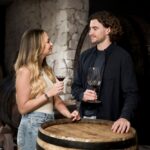 A couple enjoying a wine tasting tour at a winery