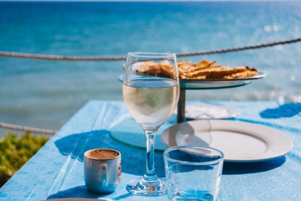 A glass of pinot gris white wine beside the sea