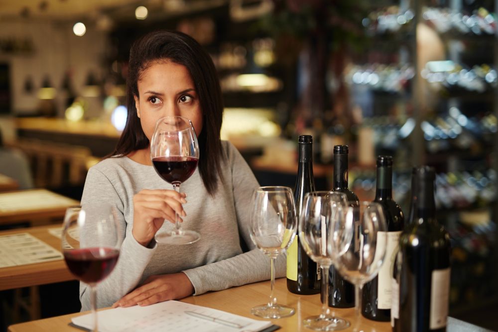 A woman smelling wine during a wine tasting session