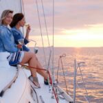 Two women drinking sparkling wine on a sailing yacht