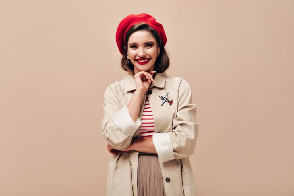 A lady in a vintage outfit with a red beret and brooch