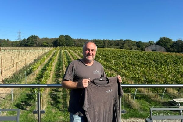 A cotton Bolney T-shirt held by a vineyard team member